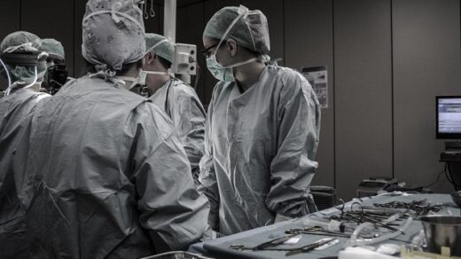 Surgeons operating in black and white