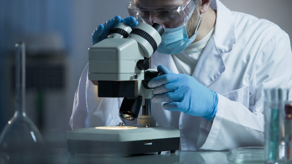 Researcher at microscope